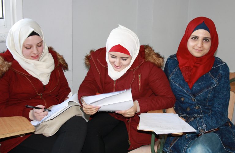 STEP! II EFL students Rana and Alaa study while Abrar smiles for the camera.